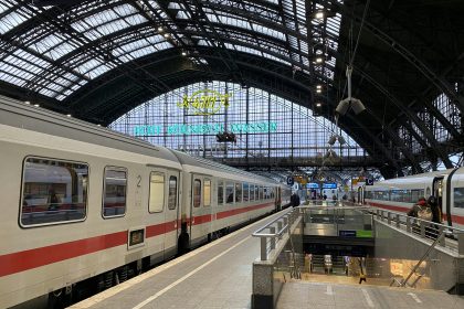 a train station with two trains parked next to each other
