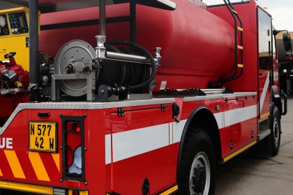 Red fire truck with white stripes and water tank