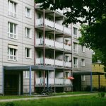 an apartment building with a bicycle parked in front of it