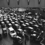 vehicles traveling on road grayscale photo