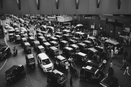 vehicles traveling on road grayscale photo