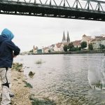 person standing beside body of water during daytime
