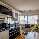 a kitchen with a table and chairs next to a window