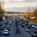Highway is experiencing heavy traffic with many cars.