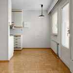 A room with a wooden floor and white walls