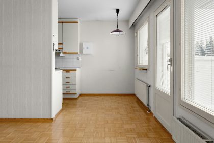 A room with a wooden floor and white walls