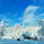 A car driving down a snow covered road
