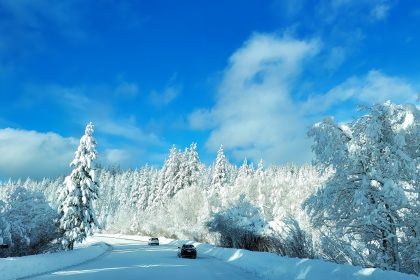 A car driving down a snow covered road