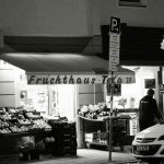 a car parked in front of a store at night