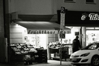 a car parked in front of a store at night