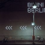 a street sign that is lit up in the dark