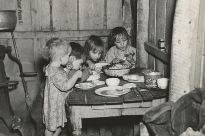 grayscale photography toddlers eating indoors