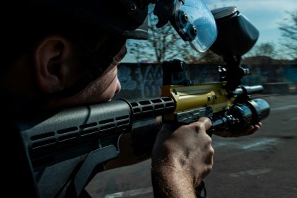 A man with a paintball gun in his hand