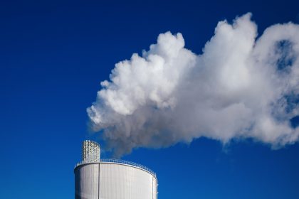 a smokestack emits from the top of a building