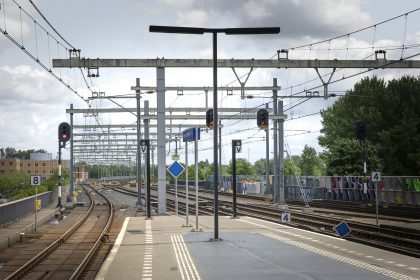 Empty train platform with tracks and signals.