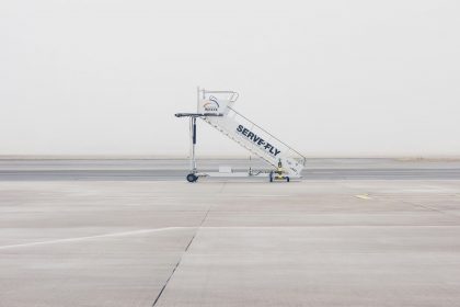 white airliner stairs on runway