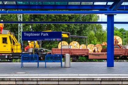 Train station with yellow engine and cargo
