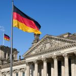 a german flag flying in front of a building