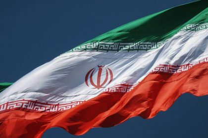 the flag of the country of iraq flying in the sky