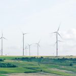 windmill surrounded by grass during daytime