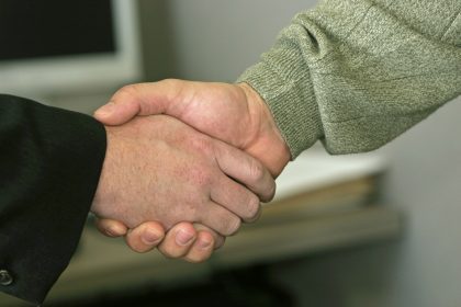 a close up of two people shaking hands