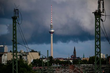 Fernsehturm tower against a cloudy sky