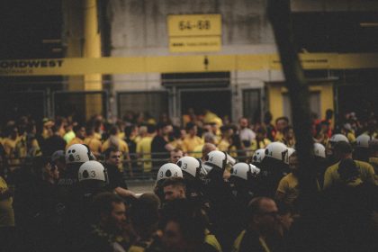 a large group of people wearing helmets in front of a building