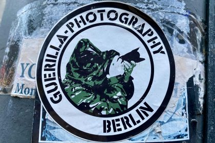 a sticker on the side of a pole with a picture of a man holding
