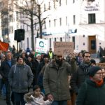 a large group of people walking down a street