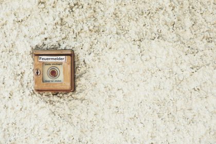 an old fashioned camera on a white carpet