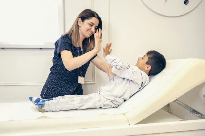 a woman is giving a boy a high five