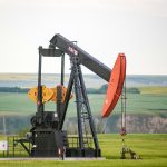 black and orange metal machine on green grass field during daytime